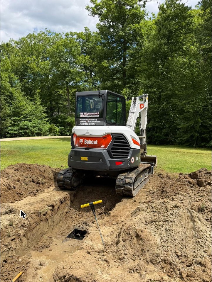 Wykowski Mechanical Bobcat excavator digging a sewer line