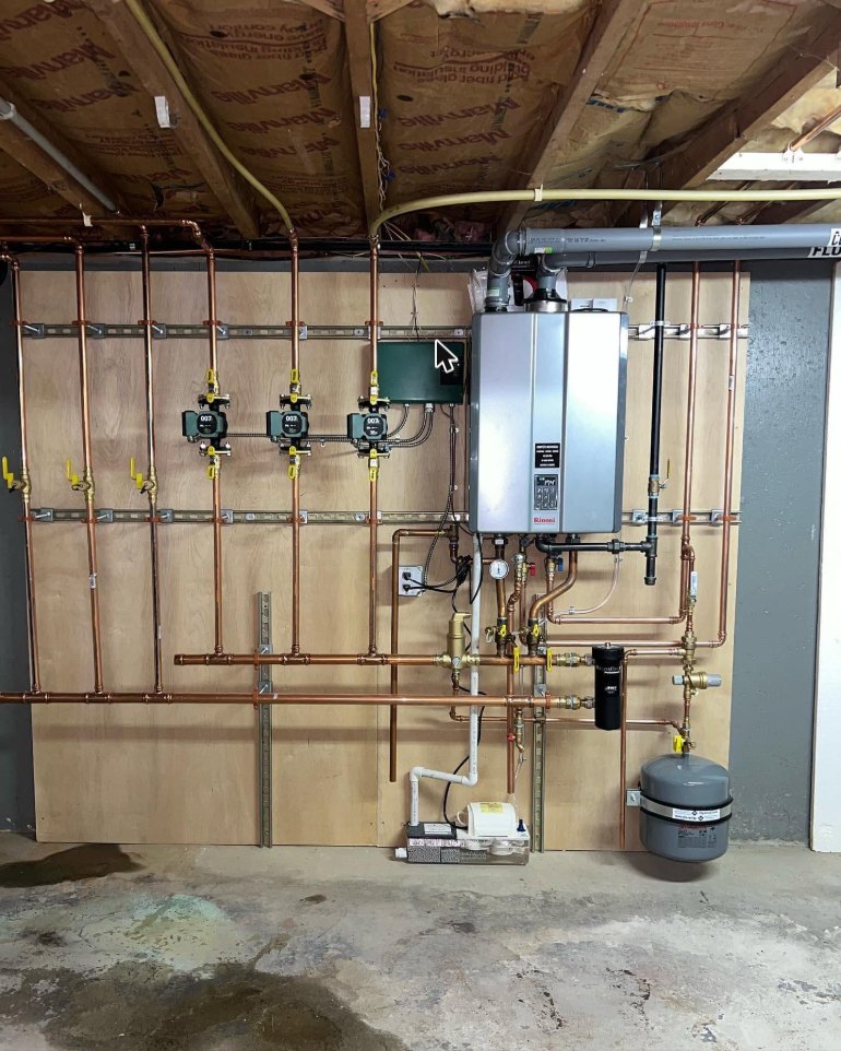 Tankless water heater and copper heating manifold installed by Wykowski Mechanical